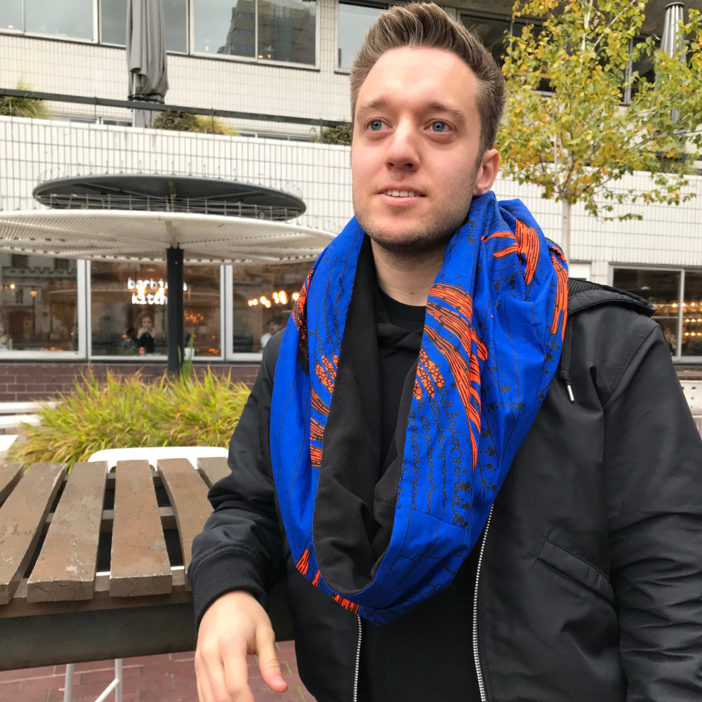 white man wearing African print scarf