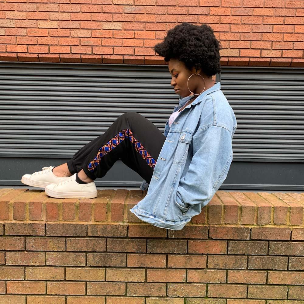 Afro woman wearing black african print jogger