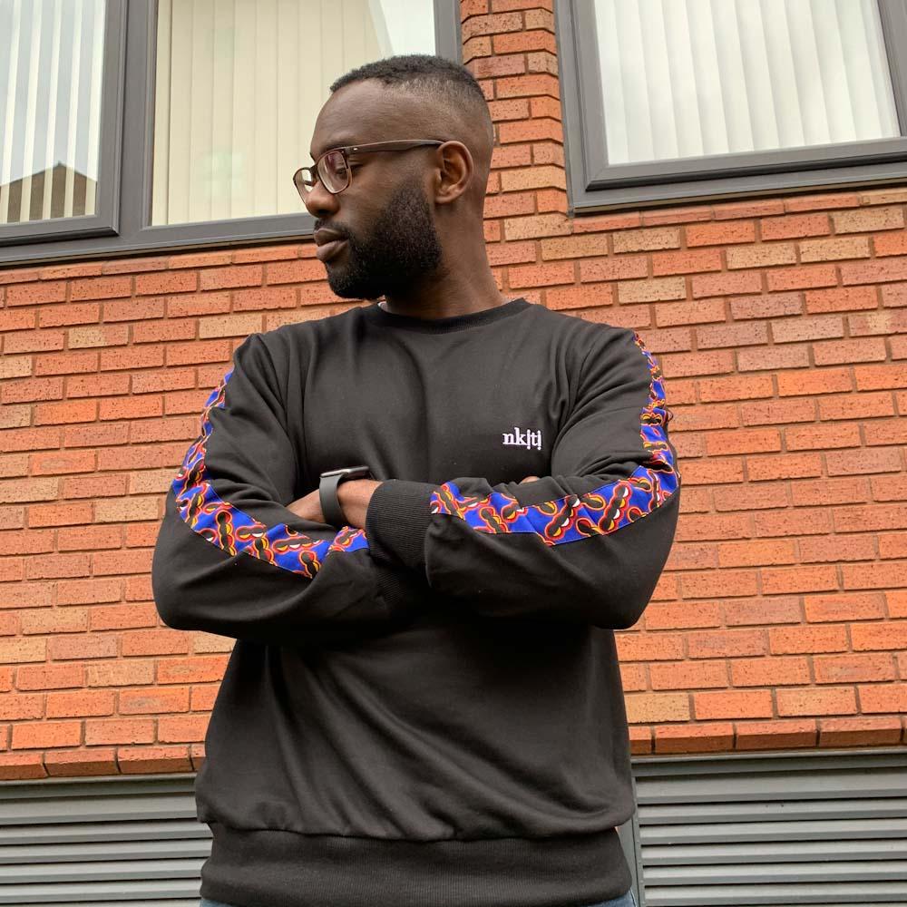 Man wearing modern african print jumper