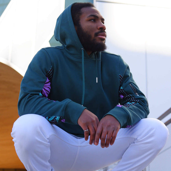 Teal African Print Hoodie Crouched Lifestyle Shot
